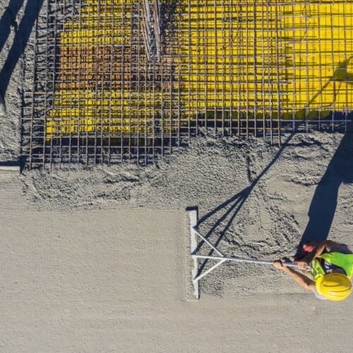Construction-workers-spreading-cement