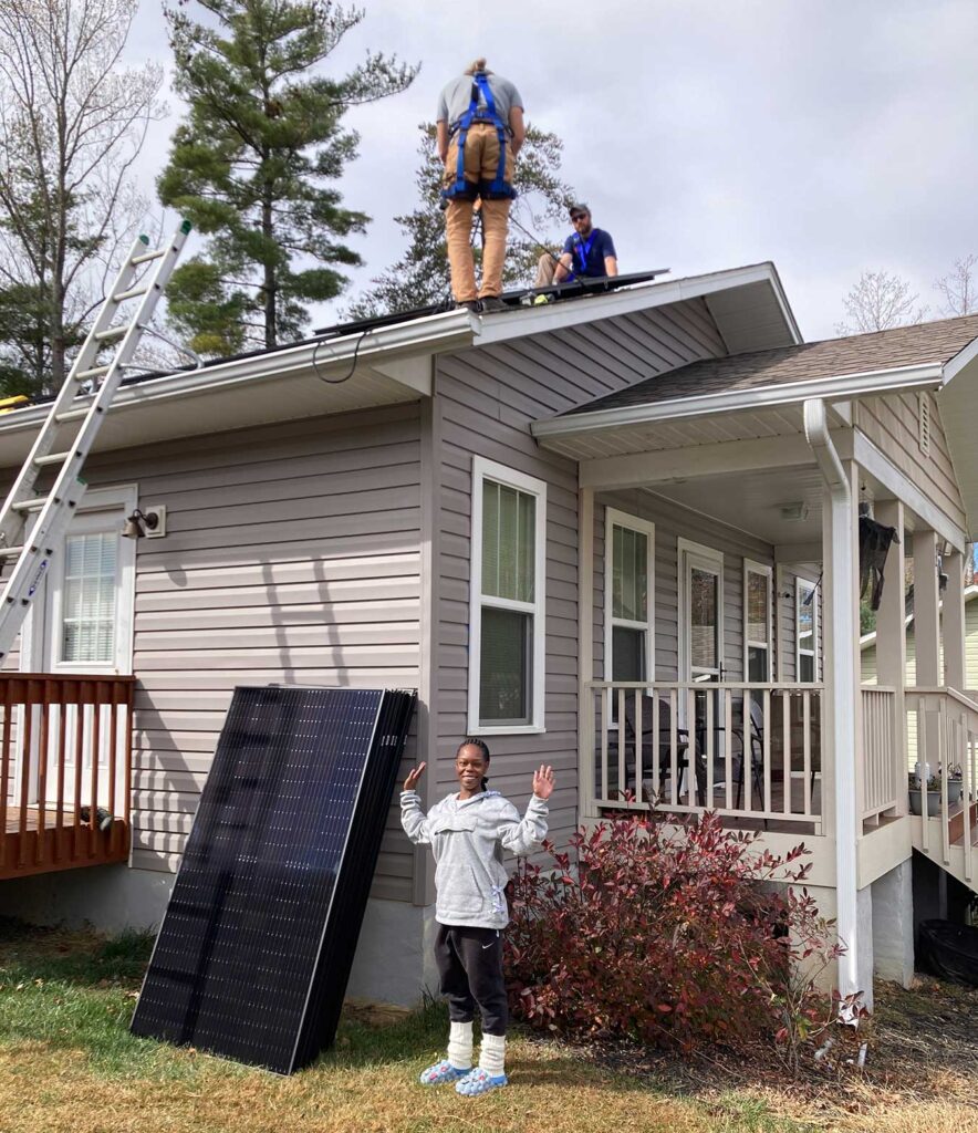 Shaketia Simpson excited about the solar panels being installed on her roof in Asheville, North Carolina Photo courtesy Sugar Hollow Solar