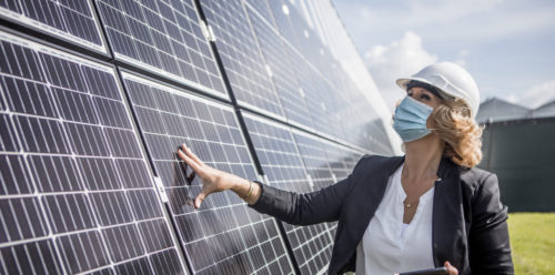 female manager beside solar panel