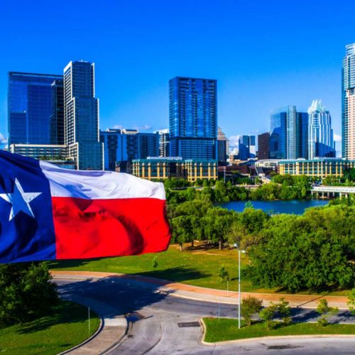 Texas flag in front of city