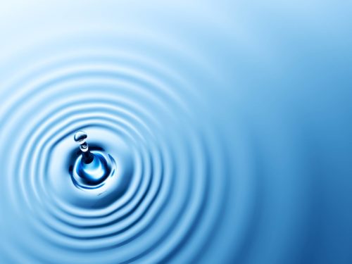 water droplet hitting water causing ripples