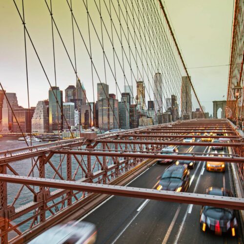 NY bridge with traffic and city backdrop