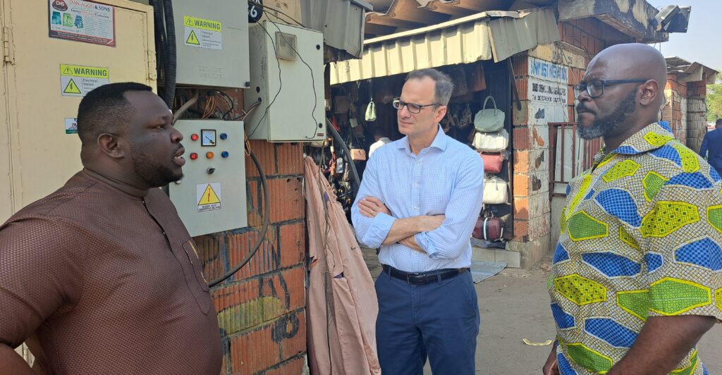 Ifeanyi Orajaka (left), CEO of renewable energy developer Green Village Electricity (GVE) Projects Ltd. who partnered with RMI to build the solar minigrid at Abuja’s Wuse Market, talks about the project with RMI’s chief executive Jon Creyts and Raul Alfaro-Pelico, senior director of RMI’s Africa Energy Program and the Energy Transition Academy.