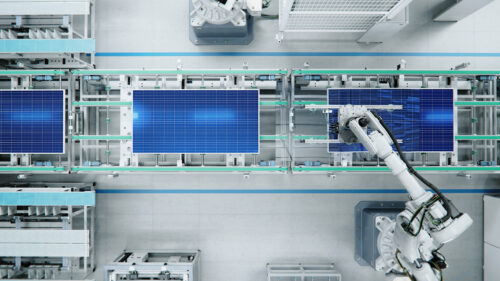 Top View of Solar Panel Assembly Line with Robot Arms at Modern Bright Factory. Solar Panel Production Prodcess at Automated Facility